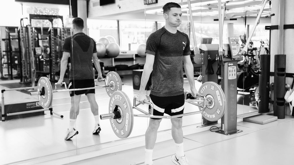 Athlete training with barbell